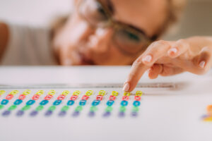 An individual meticulously arranging items in precise order and symmetry, showcasing an intense need for structure and control in their environment.